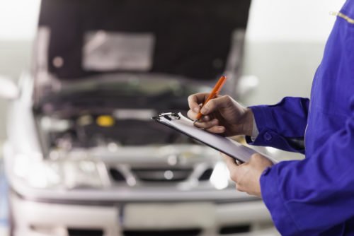 Car mechanic doing paperwork