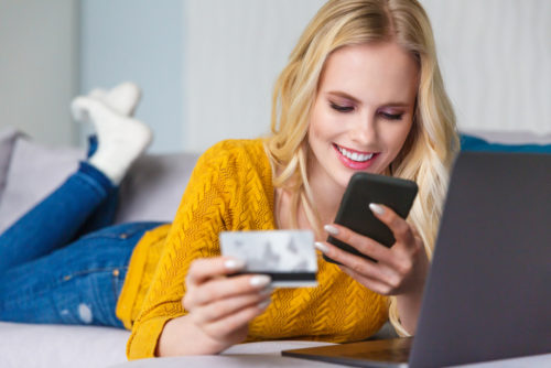 Young woman holding credit card