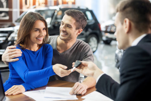 Couple buying car from salesman