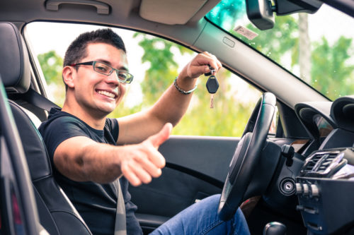 Man in car happy after buying out lease