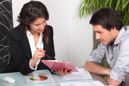 Woman showing man how a home equity loan works