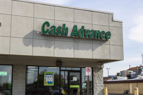 A storefront with a green cash advance above the door.