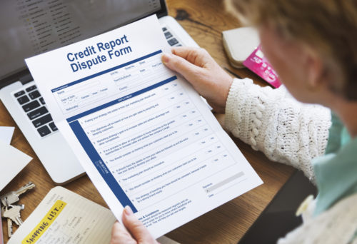Woman holding a credit report dispute form