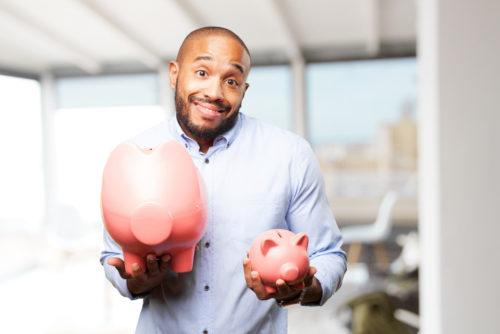 man weighs two piggy banks