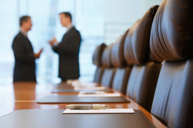 Trustees manage their trust in a boardroom.