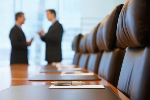 Trustees manage their trust in a boardroom.