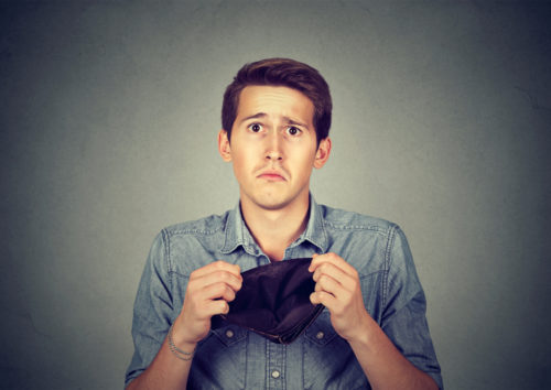 Man holding an empty wallet.