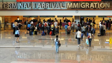 Immigrants arrive at the immigration terminal of an airport.