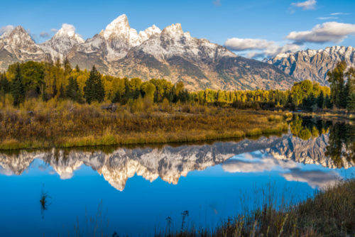 A photo of mountains reflected in a pool of water in Grand Tetons National Park, Wyoming