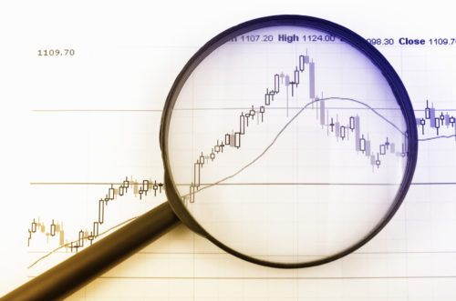 An image of a magnifying glass sitting over a graph.