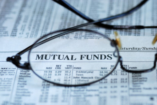 An image of eyeglasses sitting on top of a newspaper, clarifying the words "mutual funds."