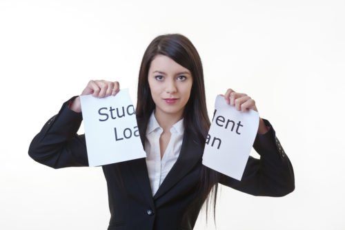 A woman ripping a sign that says "student loans" in half.