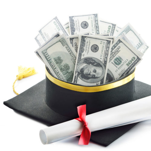 A diploma balances on top of a graduation cap, which is upside down and filled with cash.
