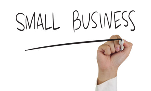 A hand holds a marker underlining the words "small business."