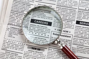 A newspaper with a magnifying glass over it, making the "careers" section clear.