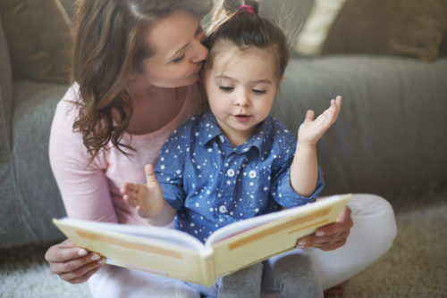 A single mother reading to her child.