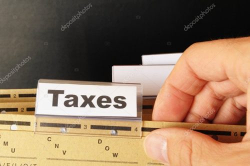 Brown filing dividers, the front divider is labeled “taxes.”