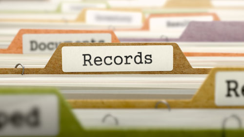 Close-up of file folders, with one labeled "Records" in focus