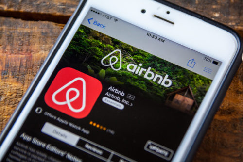 A smartphone screen displays the Airbnb app.