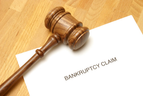 A gavel sits on top of a document titled "bankruptcy claim."