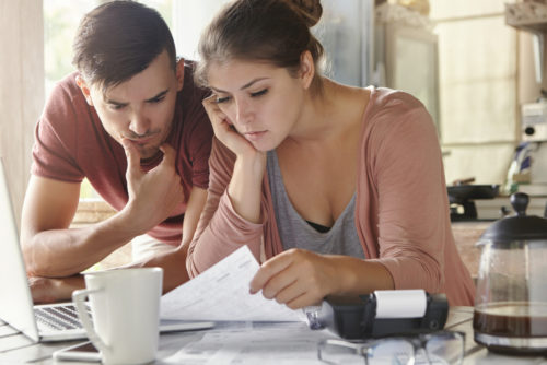 A couple looking over documents to determine their good and bad debt.