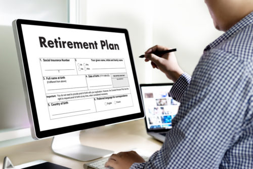 A prospective student checking his 401(k) on a computer screen that reads "retirement plan" to see if he can pay for his education.