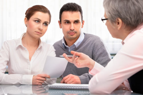 A man and woman talk to a financial planning consultant about cosigning.