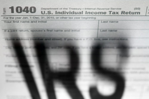 The words "IRS" cast a looming shadow over tax forms.