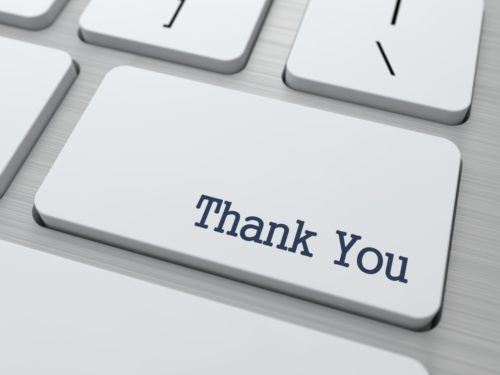 A closeup of a keyboard where one key reads "thank you."
