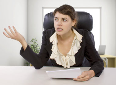 An intern looking annoyed that her internship is unpaid.