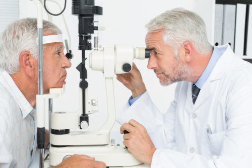 An eye doctor examines a man for cataracts.