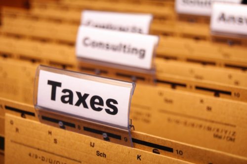 A file folder with labels including "taxes," "consulting," and more.
