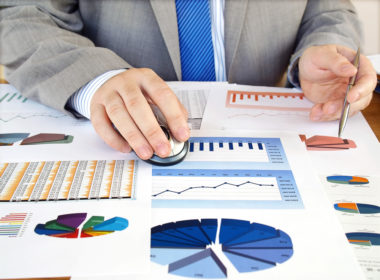 A financial advisor examining investment graphs and figures.