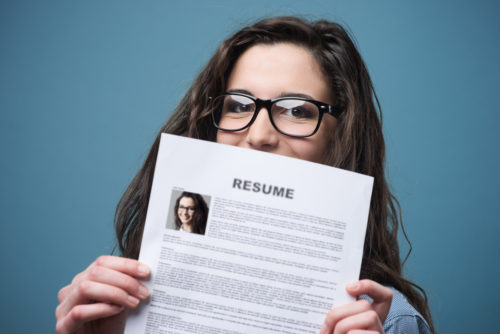 A nurse holds up her resume.