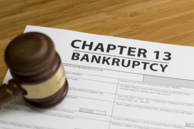 A gavel sits on top of a document labeled "chapter 13 bankruptcy."