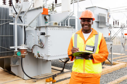 An electrical engineer checking an electrical substation.