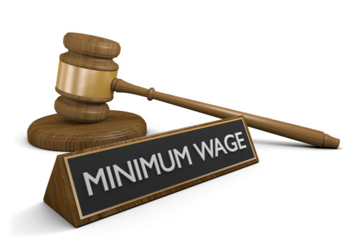A graphic of a placard that reads "minimum wage," with a gavel behind it.