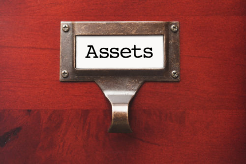 A wooden cabinet labeled "assets."