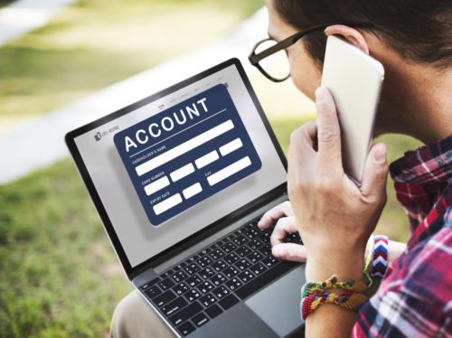 A man checks his account on a computer.