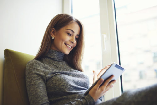 A woman using a banking app on a mobile device.