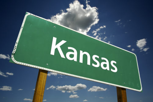 A road sign that reads "Kansas."