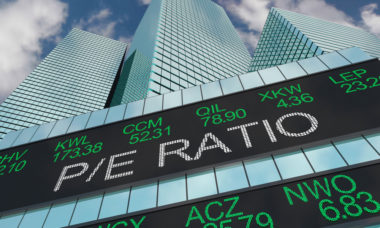 A stock ticker displays numerous stock figures, as well as the words "P/E ratio."