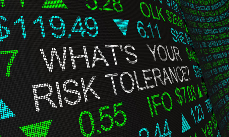 A stock exchange board displays many figures as well as the words "what's your risk tolerance."