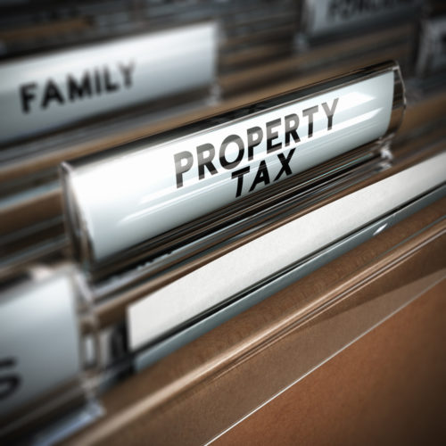 A folder in a file cabinet is marked "property tax."