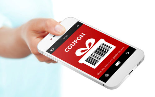 A hand holding a smartphone with a screen that displays a coupon.