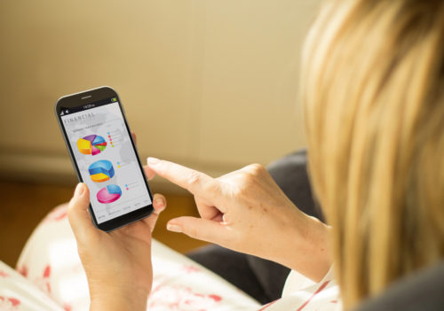 A woman using a personal finance app on her smartphone.