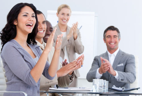Office employees applauding the benefits they've just received.