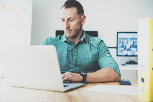 A man using his computer to set up an online banking account with a credit union.