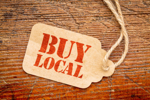A price tag that reads "buy local."