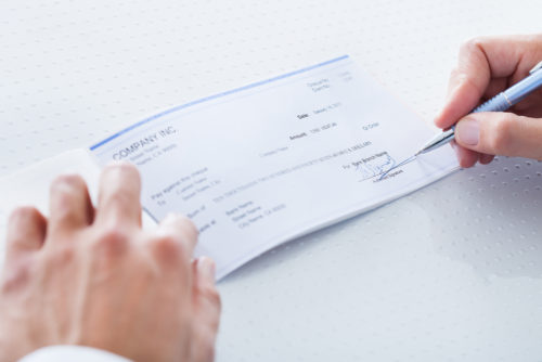 A man signing a check.